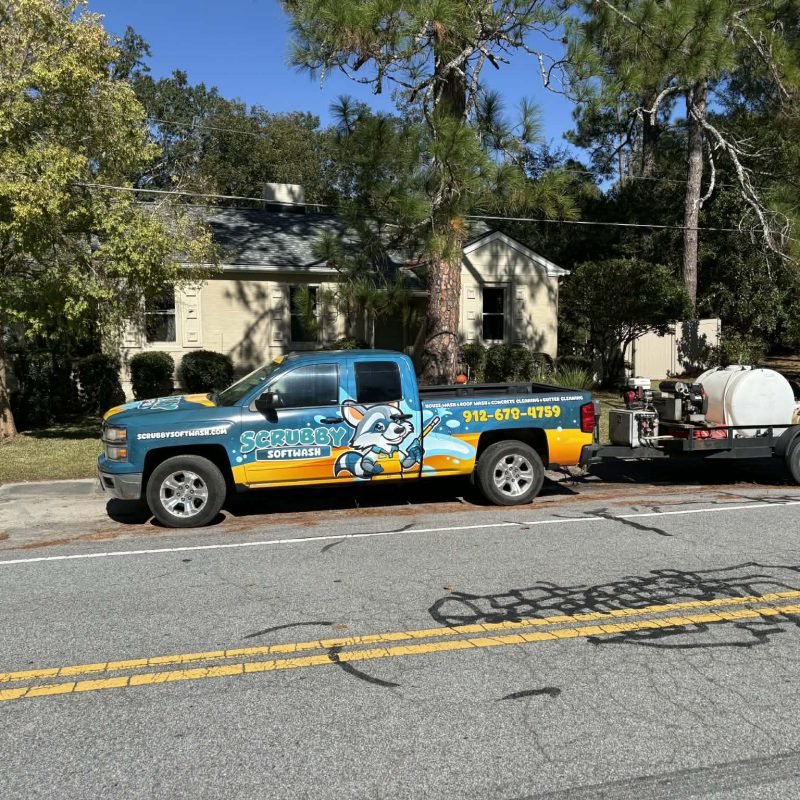 Work truck parked in front of pressure washed house